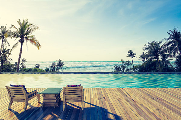 beach chairs on dock with palm trees